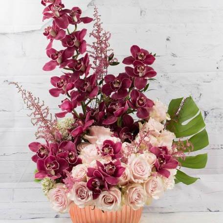 cymbidium orchids and pink roses